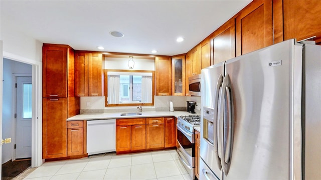 kitchen featuring sink, light tile patterned floors, and appliances with stainless steel finishes