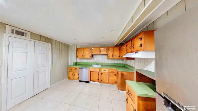 kitchen featuring stainless steel appliances, light tile patterned flooring, and sink