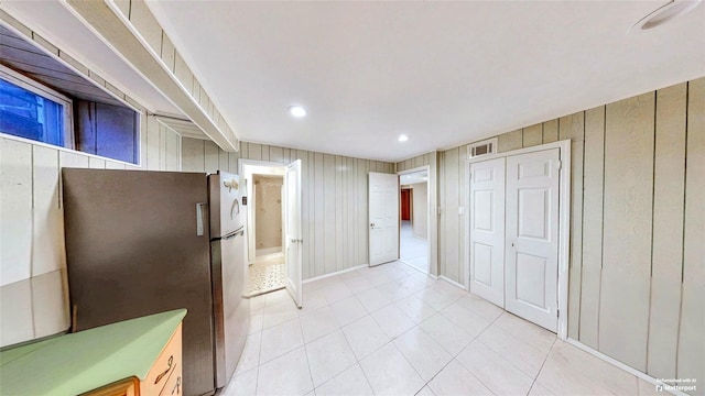 kitchen with stainless steel fridge and light tile patterned flooring