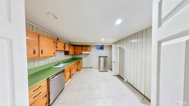 kitchen featuring dishwasher, sink, and light tile patterned flooring