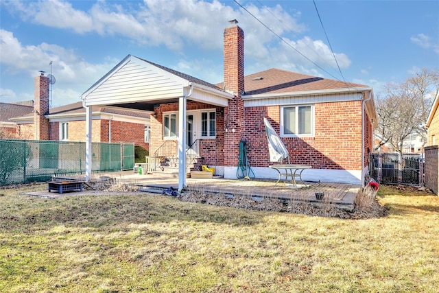 back of property with a patio area and a lawn