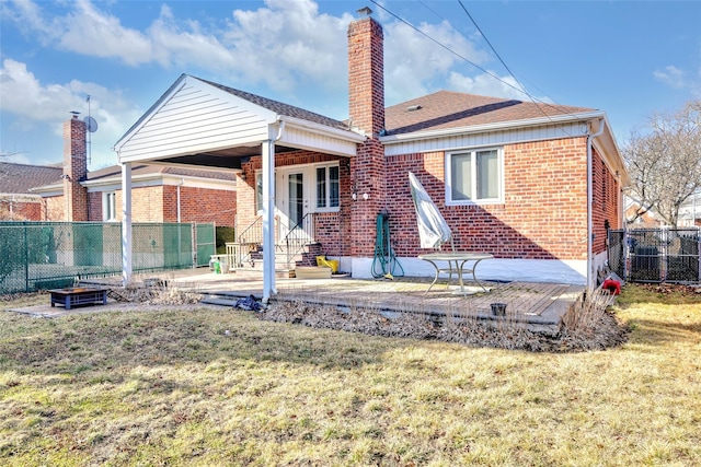 back of property featuring a patio area and a lawn