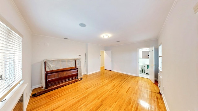 unfurnished room with ornamental molding and hardwood / wood-style floors