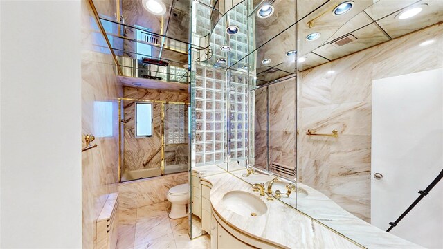 full bathroom featuring tiled shower / bath, vanity, and toilet