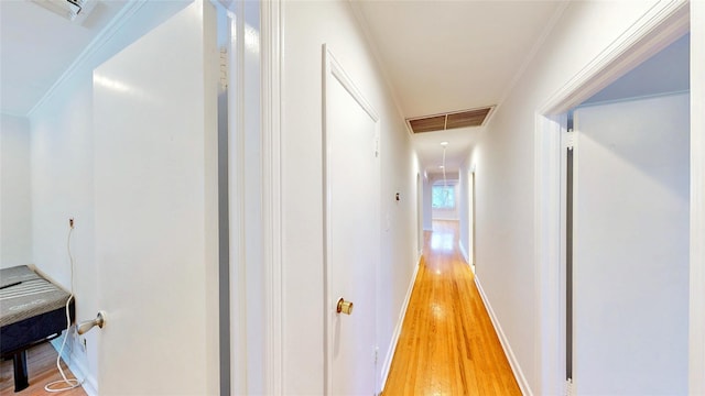 hall featuring wood-type flooring and ornamental molding