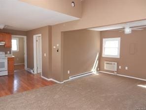 interior space with an AC wall unit, plenty of natural light, exhaust hood, and stove