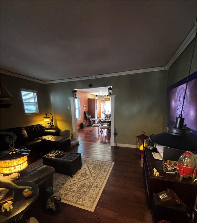 living room featuring plenty of natural light, ornamental molding, and dark hardwood / wood-style floors