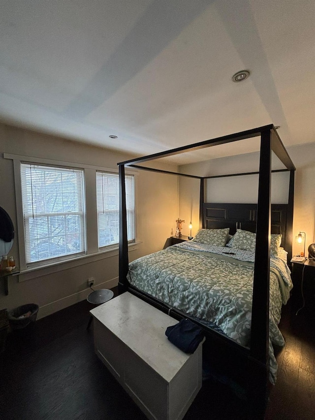 bedroom with dark hardwood / wood-style flooring