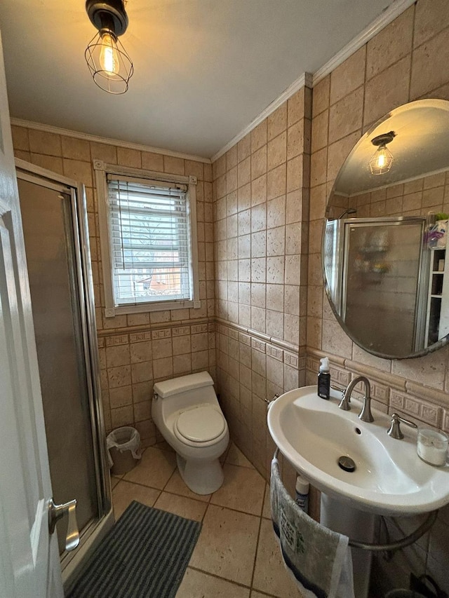 bathroom featuring crown molding, tile walls, an enclosed shower, tile patterned floors, and toilet