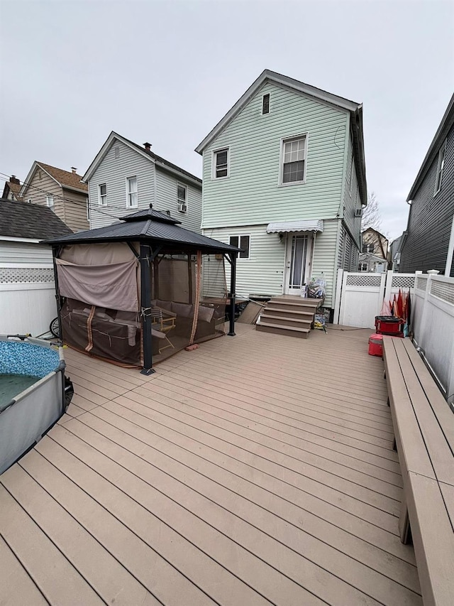 wooden terrace featuring a gazebo