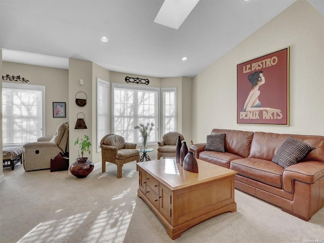 living room featuring light colored carpet and a skylight