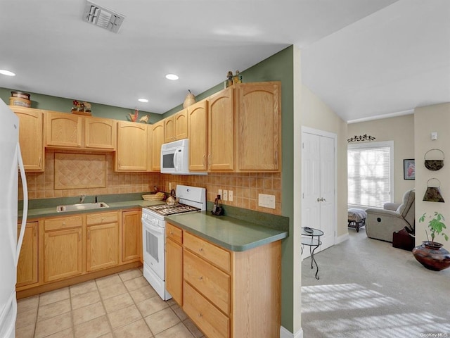 kitchen with tasteful backsplash, white appliances, light brown cabinetry, and sink