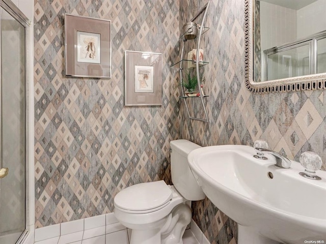 bathroom featuring sink, tile patterned floors, toilet, and walk in shower