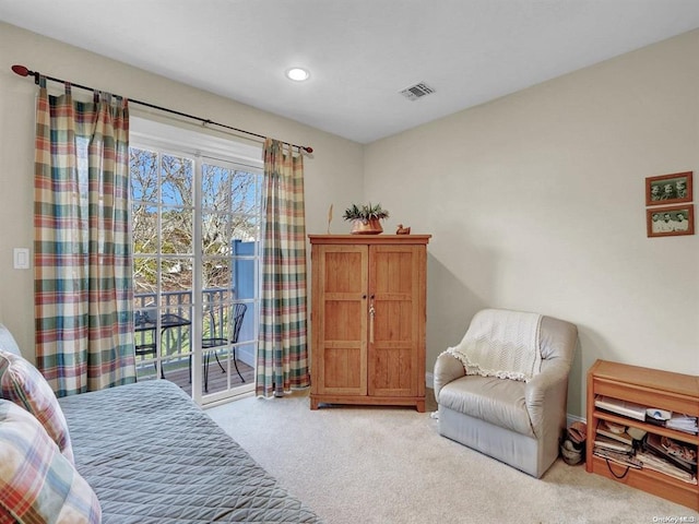 bedroom featuring access to exterior and light carpet