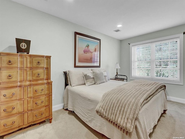 bedroom with light colored carpet