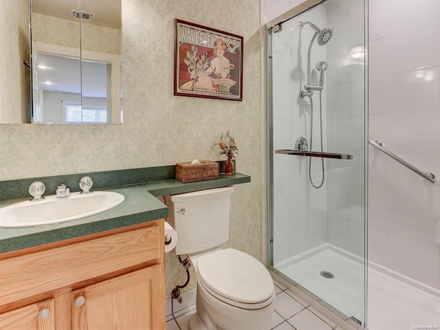 bathroom with vanity, tile patterned flooring, a shower with shower door, and toilet