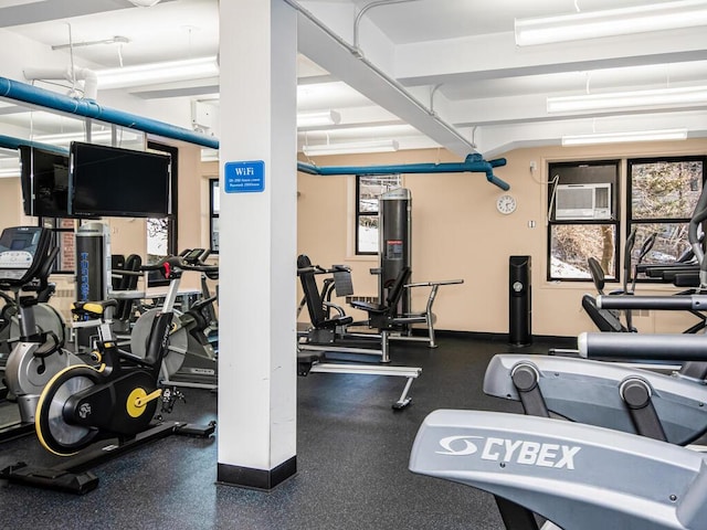 gym featuring a wall mounted air conditioner