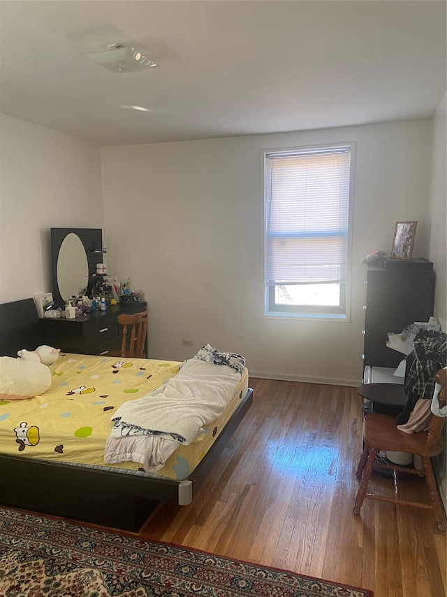 bedroom with hardwood / wood-style flooring