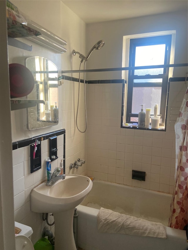 bathroom featuring tile walls, backsplash, plenty of natural light, and shower / bath combination with curtain