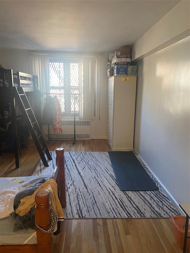 interior space featuring radiator heating unit and wood-type flooring