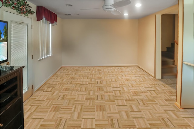 unfurnished room featuring light parquet flooring and ceiling fan