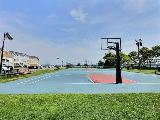 view of basketball court with a yard