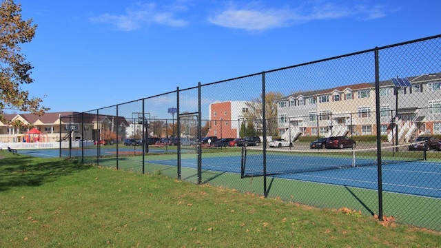 view of sport court featuring a yard