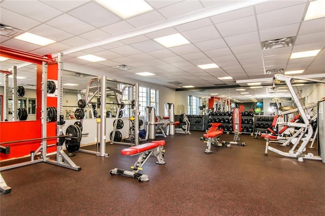 gym with a paneled ceiling