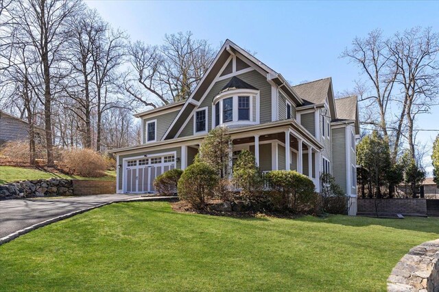699 Ardsley Rd, Scarsdale, NY 10583 - view of front of house featuring a front yard, an attached garage, and driveway