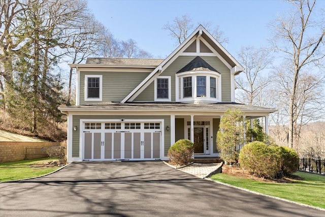 699 Ardsley Rd, Scarsdale, NY 10583 - view of front of home featuring a garage, driveway, and fence