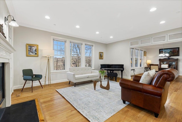 699 Ardsley Rd, Scarsdale, NY 10583 - living room with a glass covered fireplace, recessed lighting, light wood-type flooring, and baseboards