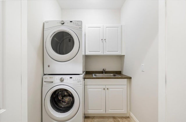 699 Ardsley Rd, Scarsdale, NY 10583 - washroom featuring baseboards, stacked washer and dryer, a sink, and cabinet space