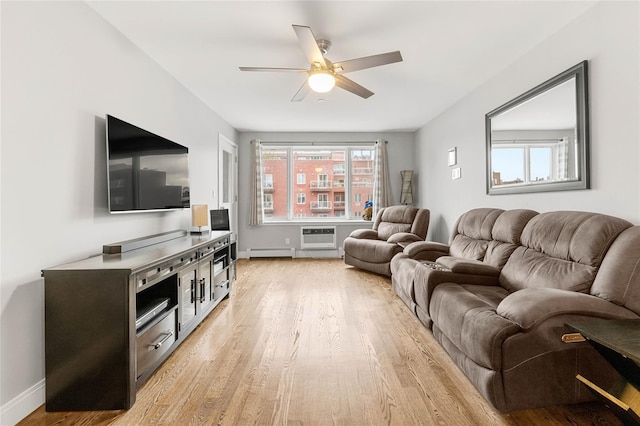 living room featuring ceiling fan, an AC wall unit, a baseboard heating unit, and light hardwood / wood-style floors