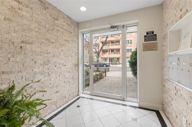 doorway to outside with mail boxes and light tile patterned floors