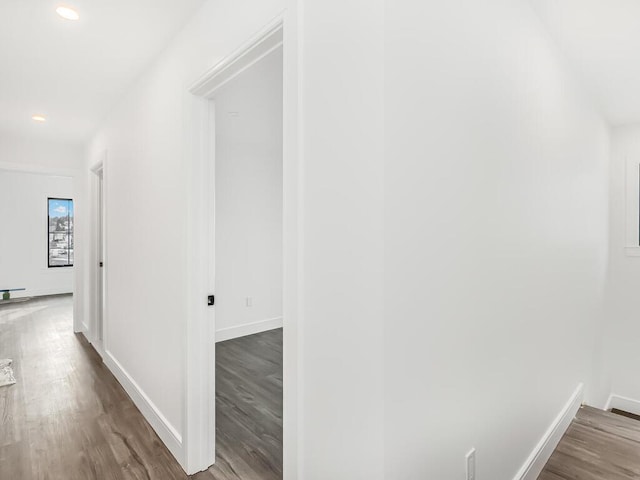 hallway with hardwood / wood-style floors