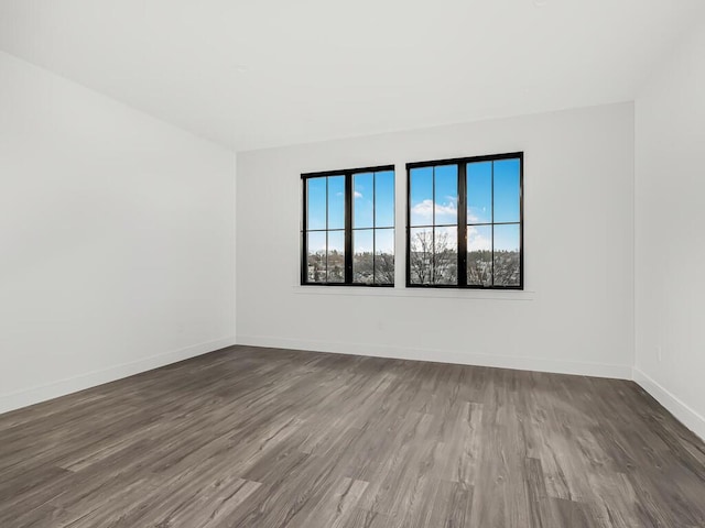 unfurnished room featuring dark hardwood / wood-style flooring