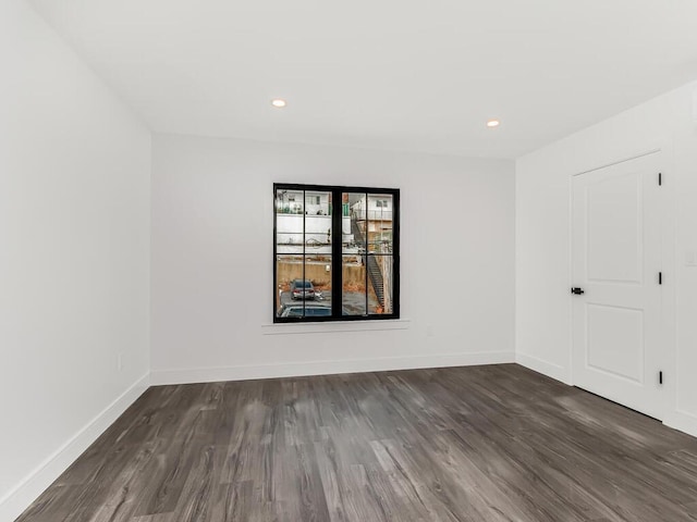 spare room featuring dark wood-type flooring