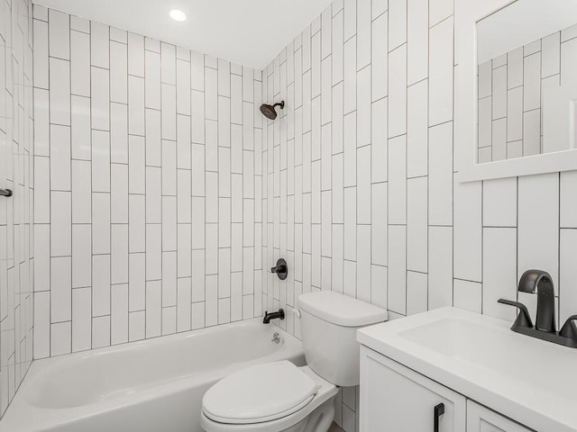 full bathroom with toilet, tiled shower / bath combo, sink, and tile walls