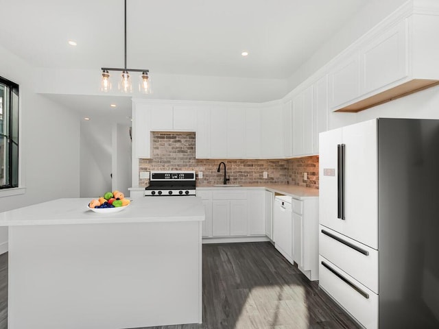 kitchen with white cabinetry, a center island, white appliances, and decorative light fixtures