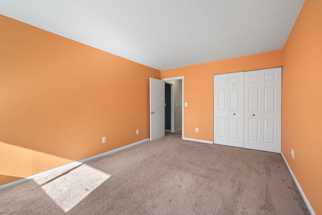 unfurnished bedroom featuring carpet floors and a closet