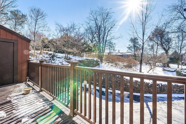 view of snow covered back of property