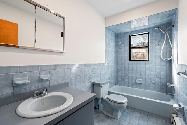 full bathroom with tile walls, tiled shower / bath combo, vanity, a baseboard radiator, and toilet