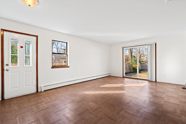 foyer featuring a baseboard heating unit and parquet floors