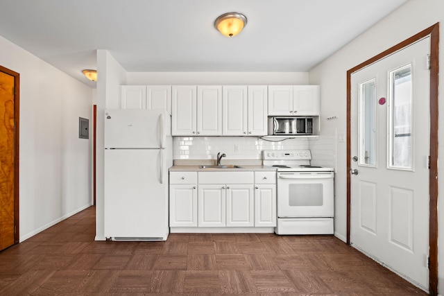 kitchen with tasteful backsplash, sink, white cabinets, and white appliances