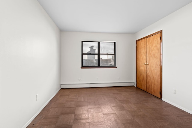 unfurnished bedroom featuring a baseboard radiator