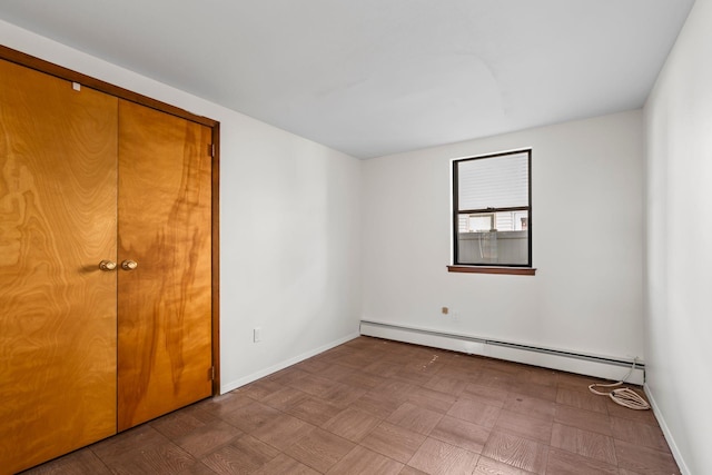 unfurnished bedroom with baseboard heating