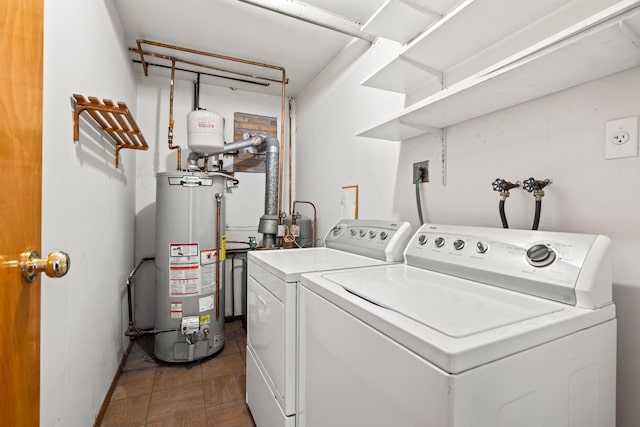 laundry area with independent washer and dryer and water heater