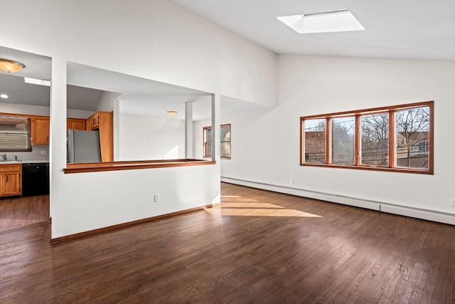 unfurnished living room with lofted ceiling with skylight, dark wood-type flooring, and baseboard heating