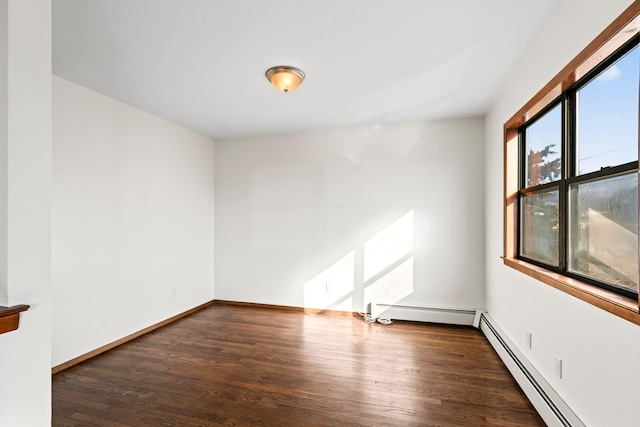 empty room with a baseboard radiator and dark hardwood / wood-style flooring