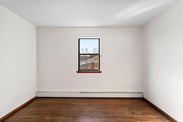 unfurnished room with dark hardwood / wood-style flooring and baseboard heating